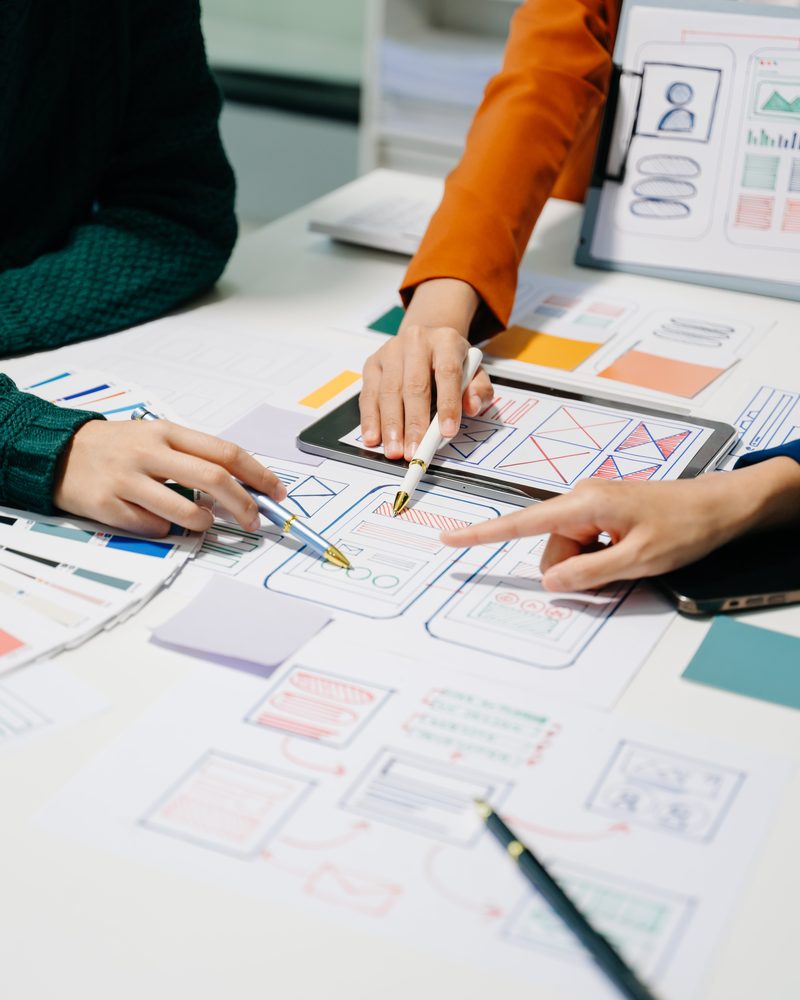 Top-down view of designers planning a new product
